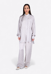 Front view of model wearing white printed shirt with matching trousers, East Vibe